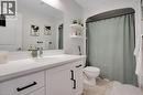 Full bath featuring vanity and light tile patterned flooring