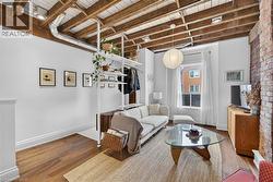 Living area featuring wood flooring and a wooden ceiling with exposed beams