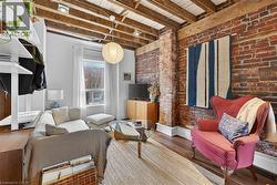 Living room featuring exposed brick wall