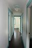 A view down the hallway. All those pops of turquoise really give this unit a 
