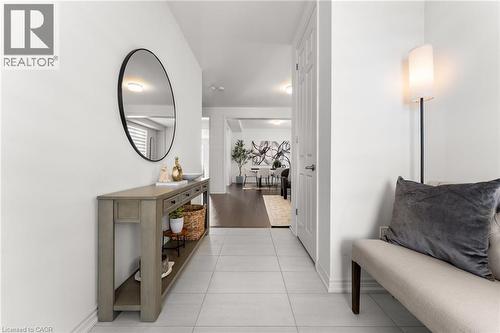 Hallway featuring baseboards and light tile patterned flooring