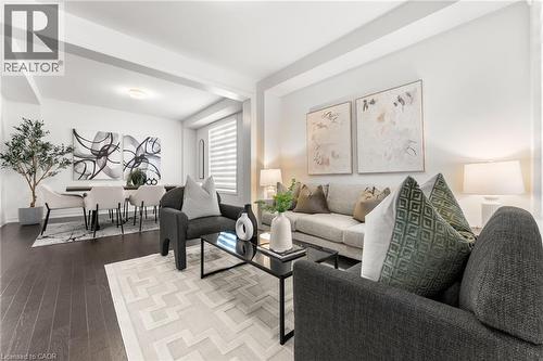 Living area with hardwood / wood-style floors and baseboards