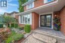 Doorway to property featuring brick siding and french doors