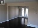 Open concept living room and dining room with french doors leading to rear yard