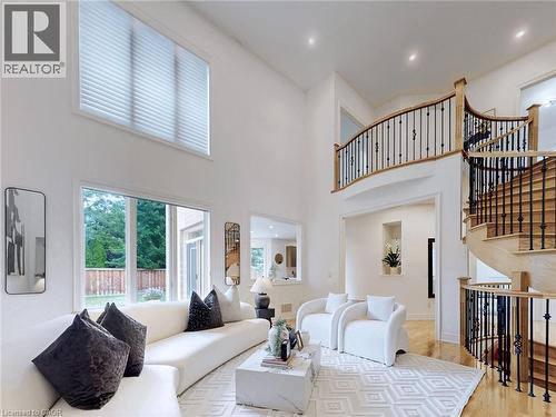 Living room featuring recessed lighting, wood finished floors, and a high ceiling
