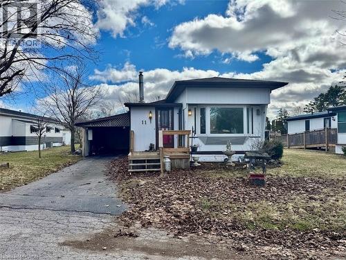 View of front of home featuring a carport and asphalt driveway