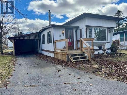 Manufactured / mobile home with an attached carport and asphalt driveway