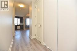 Hall featuring light wood-style flooring and baseboards