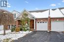 View of front of home featuring brick siding, driveway, and an attached garage
