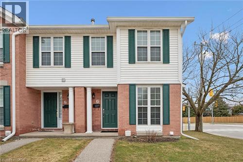 View of front of home featuring covered porch and brick siding