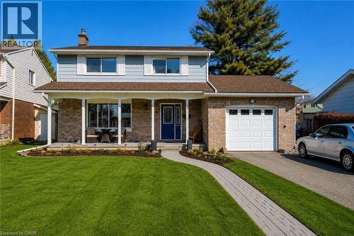 Two-story residence featuring light blue siding and brick detailing