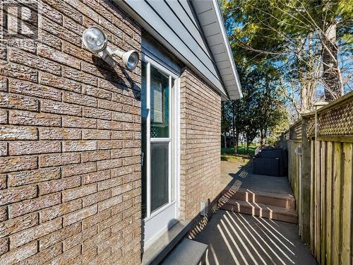 Brick exterior featuring white trim and a siding soffit