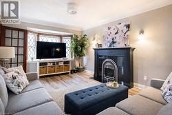 Living area with light wood-style flooring and a fireplace with flush hearth