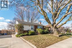 Bungalow-style home with brick siding and a front yard