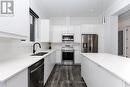 White gloss cabinetry with sleek push cabinetry