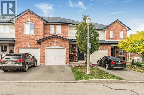 Traditional home with brick siding, driveway, and a garage