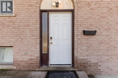 View of exterior entry with brick siding