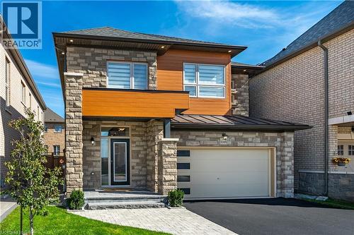 Modern stone and wood facade with an integrated garage
