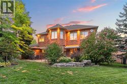 The property features a brick exterior with multiple windows and exterior lighting
