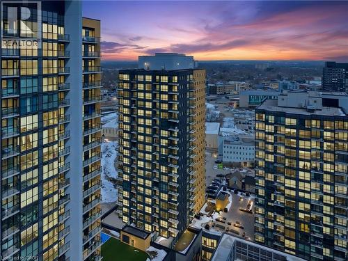 Aerial view of the property and surrounding buildings, featuring modern architecture with extensive window facades