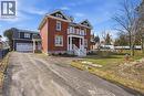 This property features a brick exterior with white trim and a prominent white balcony