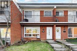 The property features a brick exterior with white-framed windows and doors
