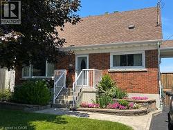 Brick exterior with a brown shingled roof