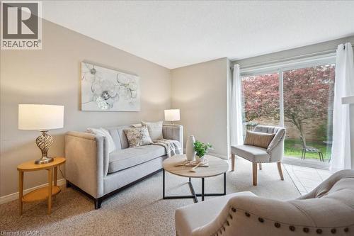 Carpeted living area with healthy amount of natural light