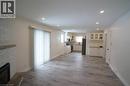 Open-concept living area with wood-finish flooring