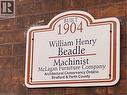 Architectural plaque mounted on a brick exterior