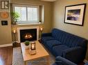 Living room with gas fireplace and hardwood floors