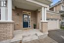 Brick facade featuring a covered entry with white columns