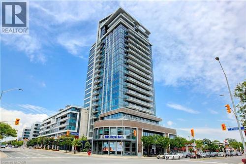 Modern high-rise building featuring extensive glass curtain walls, multiple private balconies, and a ground-level retail facade with storefront windows