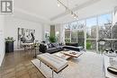 living room w/floor to ceiling windows + office