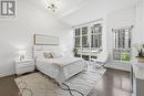 primary bedroom w/floor to ceiling windows