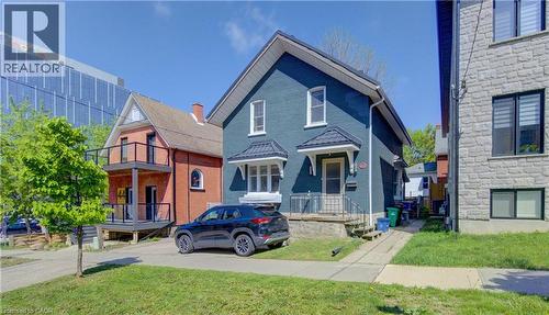 Two-story residence with steel roof, white trim windows, and a covered entry