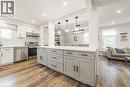 Contemporary kitchen featuring a large island with gray cabinetry and solid surface countertop