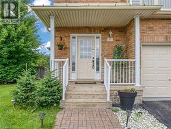 Brick-clad exterior featuring a covered porch entry with white columns and railings