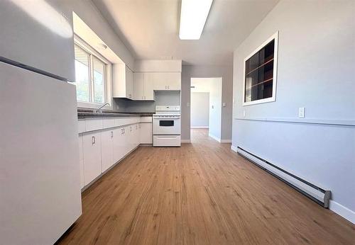 Main house with 2 bedrooms /one full bath - view of the eat in kitchen looking into the living room