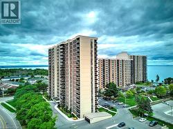 High-rise building with a light-colored facade and dark trim, featuring multiple balconies