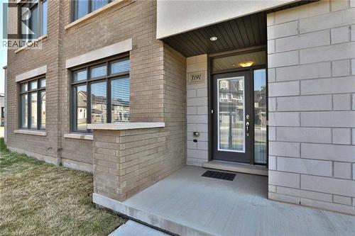 Modern facade featuring a combination of light-colored brick and stone cladding