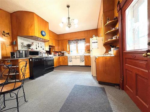 Eat in large vintage style functional kitchen with extensive natural wood cabinetry