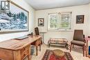 Bright room featuring two windows with horizontal blinds, providing natural light
