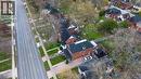 Aerial perspective showcasing a multi-story brick residence with a dark-pitched roof