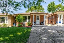Brick exterior residence with a covered front porch and a white entry door