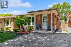 Brick exterior featuring a covered front porch with white columns