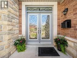 Inviting double entry doors with decorative glass panels and transom