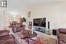 Vaulted ceiling in the living area featuring neutral wall tones and carpet flooring