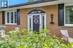 Brick exterior featuring an arched entryway with decorative accents