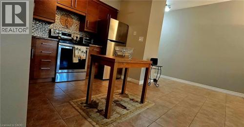 Kitchen featuring wood-finish cabinetry, stainless steel appliances, and a mosaic tile backsplash